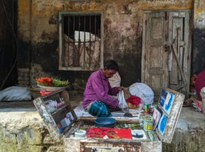 A street vendor arranges products in Chandpur, Bangladesh. Authentic urban scene.