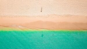 A breathtaking drone shot of Holetown Beach, Barbados, showcasing turquoise waters and golden sand.