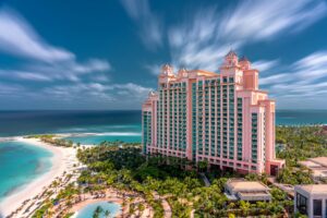 A stunning view of a luxury hotel on the Bahamas beachfront with clear blue skies and turquoise sea.