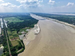 Sweeping aerial view of the Padma River flowing through Bangladesh's lush landscape.