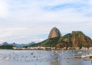 Captivating view of Sugarloaf Mountain in Rio de Janeiro with boats in the bay under a clear sky.